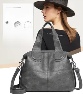 Detail of water-resistant gray leather tote bag with visible texture and stitching