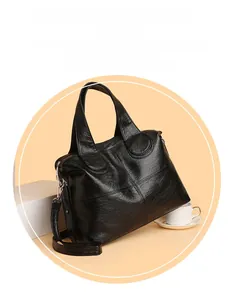 Close-up of black leather texture and stitch detail on large capacity tote bag