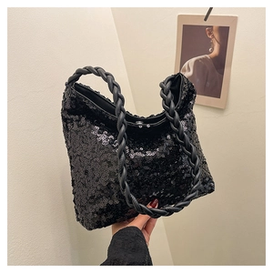 Detail of black sequined hobo bag featuring a unique twisted rope handle and shiny texture