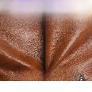Macro detail of the brown leather texture with natural grain and smooth polished finish