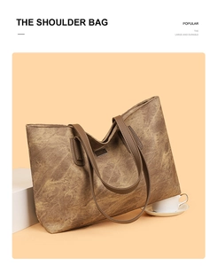 Detail of vintage brown faux leather tote bag with metallic plaque and durable shoulder straps