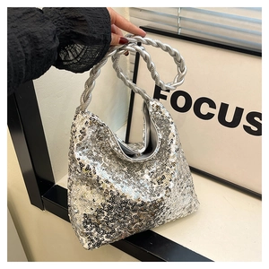 Close-up of silver sequin handbag featuring a unique thick twisted rope handle design