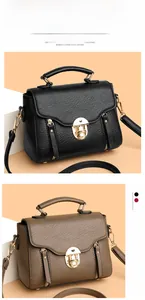 Detail of elegant square handbag with gold metal lock and textured leather finish