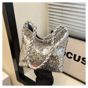 Detail of silver sequin hobo bag featuring a unique braided twist handle design