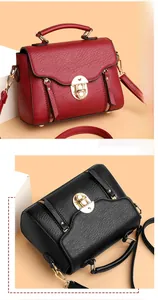 Detail of lychee pattern leather bags with golden flip lock and zipper tassel decor