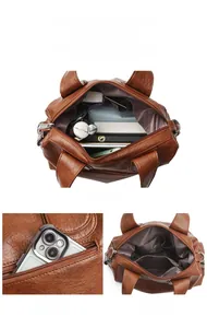 Détails du sac à main en cuir marron montrant les compartiments et la poche arrière zippée