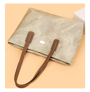 Detail view of large retro tote bag with stone texture and dark brown handles