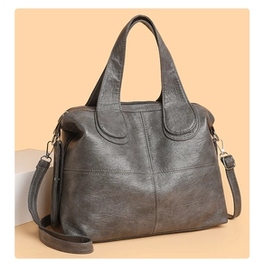 Detail view of large grey vintage tote bag with cross-stitch and detachable strap