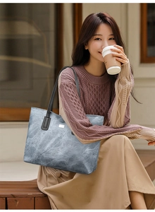 Gray-blue tote bag with marble texture shown in a casual lifestyle setting