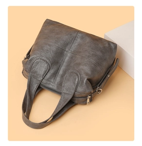 Detailed top view of a charcoal grey vintage tote bag showing retro leather texture