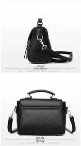 Detail of vintage black crossbody bag with lychee texture and gold metal bottom studs