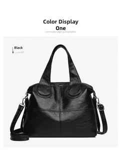 Detail of black pebbled leather tote bag with cross stitching and silver hardware