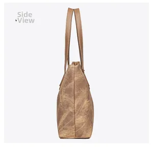 Side view of large brown vintage tote bag showing texture and stitching details