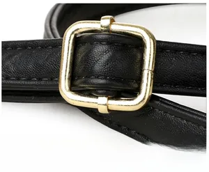 Detail of black pebbled leather strap with adjustable gold square metal buckle
