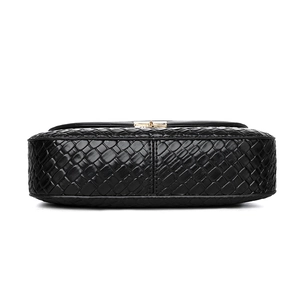 Minimalist black woven shoulder bag for women with elegant golden metal lock detail