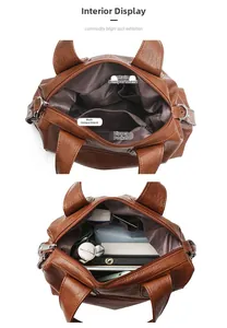 Détail intérieur d'un sac vintage marron avec deux compartiments et une poche zippée