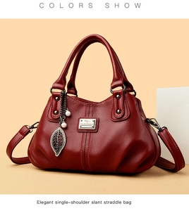 Close-up of dark red lychee grain leather handbag with pearl leaf metal charm