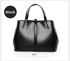 Detailed view of black textured leather tote bag with metallic studs and handle accents