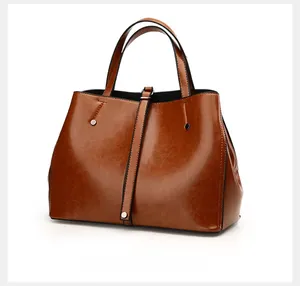 Side view of retro brown tote bag with vintage oil wax leather texture and rivet details