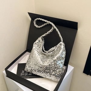 Chic silver sequin hobo bag with a twisted rope handle presented in an elegant gift box