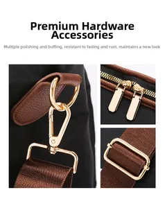 Detail of light gold lobster clasp and dual zippers on a large travel duffel bag