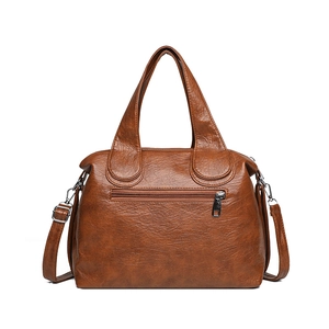 Brown faux leather crossbody handbag with lychee texture and top handle on white background