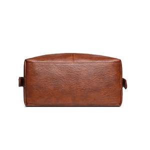 Bottom view of a vintage brown PU leather large capacity tote bag with visible texture