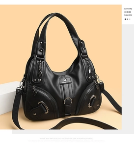 Dettaglio borsa in pelle nera testurizzata con finiture in metallo e tasche laterali zip
