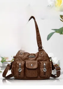 Detailed macro view of vintage brown PU leather texture and silver floral zipper on bag