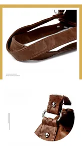 Detail of wide brown leather handle and silver metal rings on a vintage tote bag