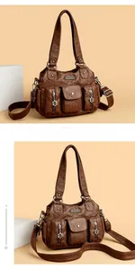 Detail of vintage brown leather tote bag showing functional pockets and metal hardware