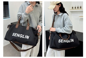 Detail of SENGLIN large capacity travel bag with contrast brown straps and gold hardware