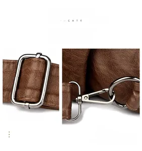 Detail of silver metal strap buckles and lobster clasps on a brown textured leather bag