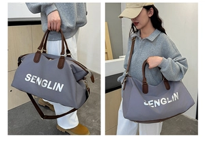 Detail of grey nylon travel bag showing brown leather handles and SENGLIN logo text