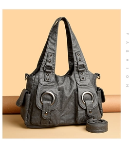 Detail of dark gray retro washed PU leather tote with metal ring and rivet accents