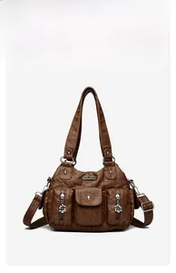 Detail of vintage brown shoulder bag showing multiple pockets and floral zipper pulls