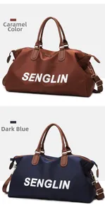 Detail view of caramel and navy blue nylon travel duffel bags with premium leather trim
