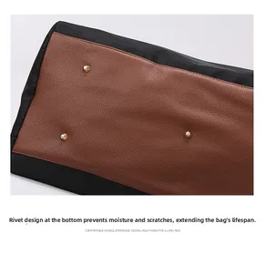 Close-up of travel bag bottom featuring brown lychee leather and gold protective metal studs