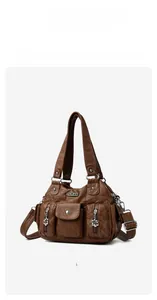 Detail view of large capacity vintage brown shoulder bag with multiple zip pockets