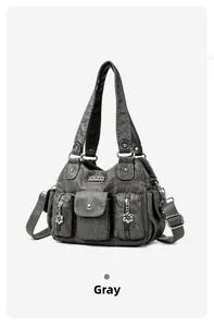 Macro shot of grey leather shoulder bag with vintage texture and floral metal zippers