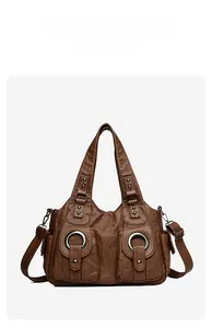 Front view of brown vintage PU tote bag featuring large metal rings and dual pockets