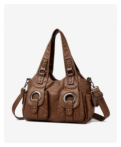 Detail view of coffee brown vintage PU leather bag with large silver rings and studs