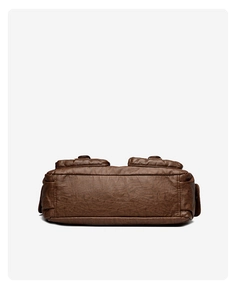 Detail view of the wide rectangular base on this vintage brown textured leather tote bag