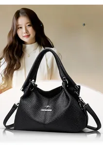 Close-up of black lychee texture leather handbag with silver kangaroo logo and hobo design
