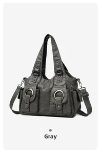 Detailed view of gray vintage washed leather handbag with metal rings and studs