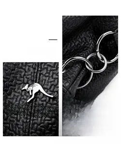 Close-up of black lychee grain leather handbag with silver kangaroo logo and hardware