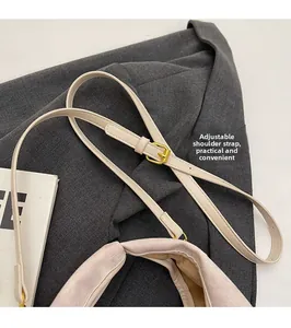Detail view of the adjustable slim leather shoulder strap with elegant gold metal buckle