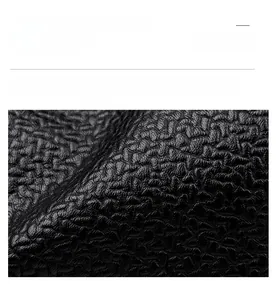 Close-up of premium black lychee grain texture with soft, durable leather material details