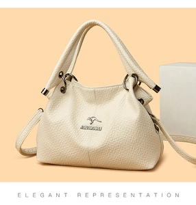 Detail of cream leather handbag showing pebble texture and kangaroo metal logo