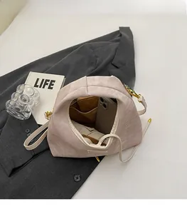 Spacious interior of corduroy shoulder bag showing capacity for phone and wallet